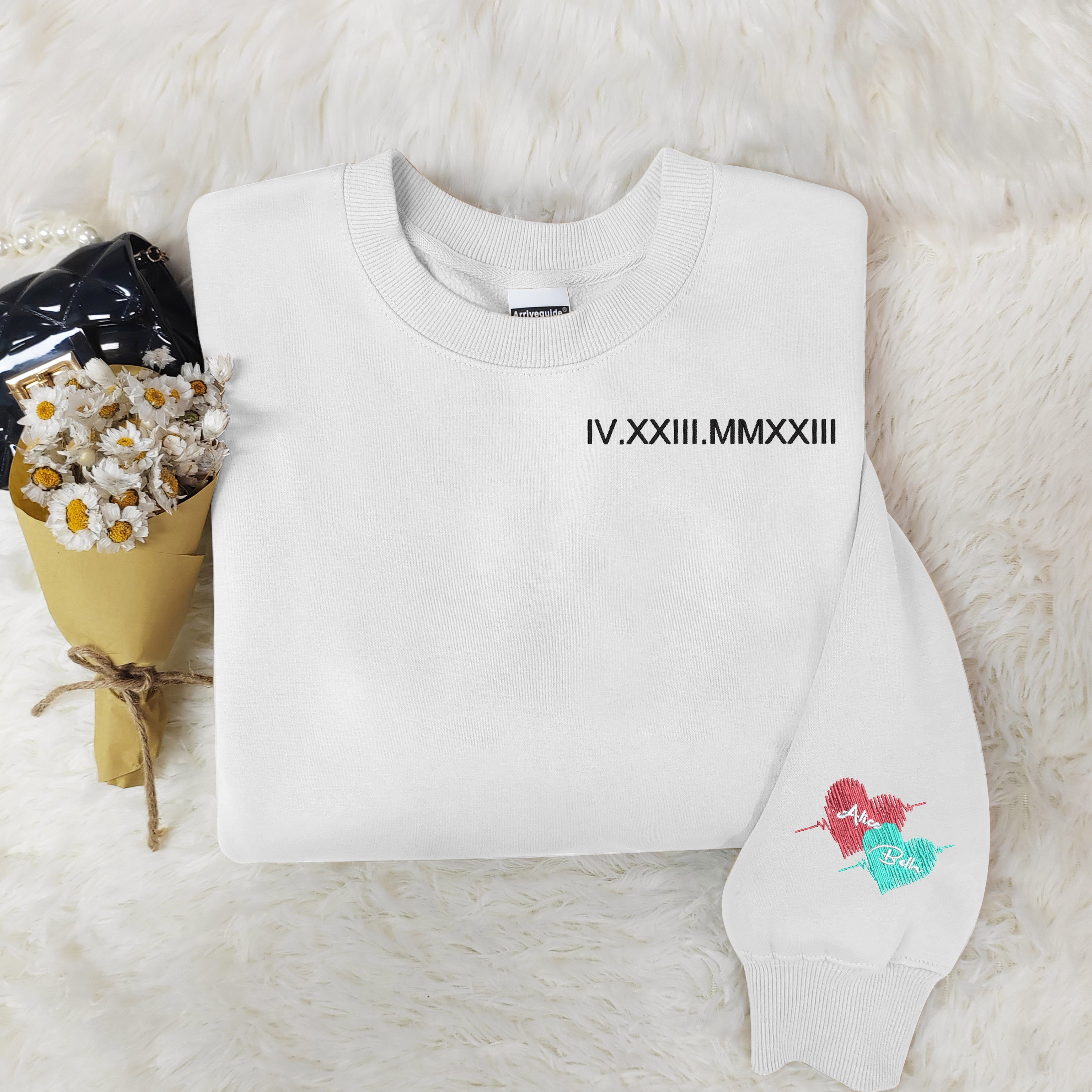 Customized Roman numeral embroidered sweatshirts for couples, with the couple’s names embroidered on the cuffs.