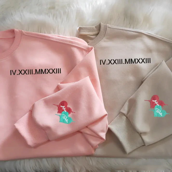 Customized Roman numeral embroidered sweatshirts for couples, with the couple’s names embroidered on the cuffs.